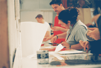 folks rolling ink onto relief blocks